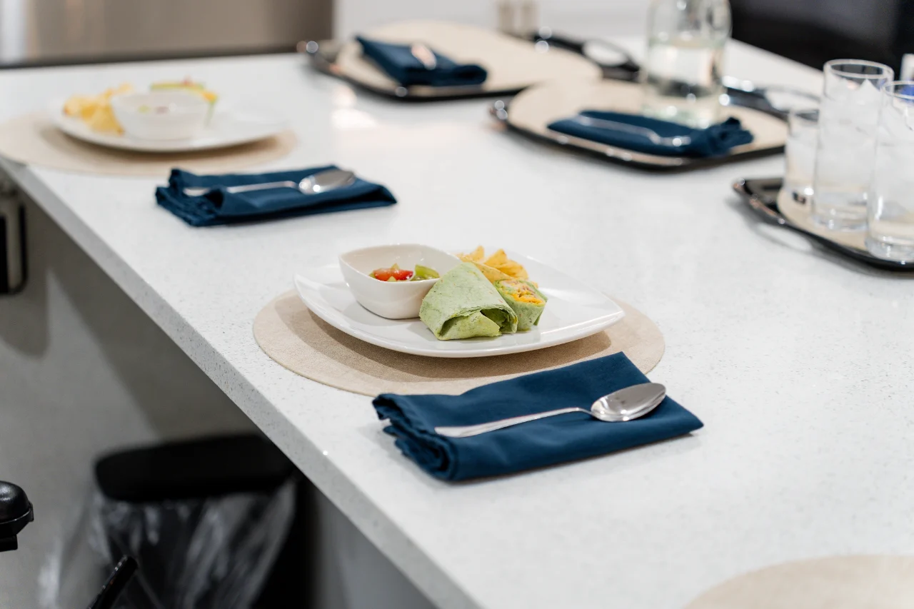 A plated wrap, side dishes and a coordinated table setting