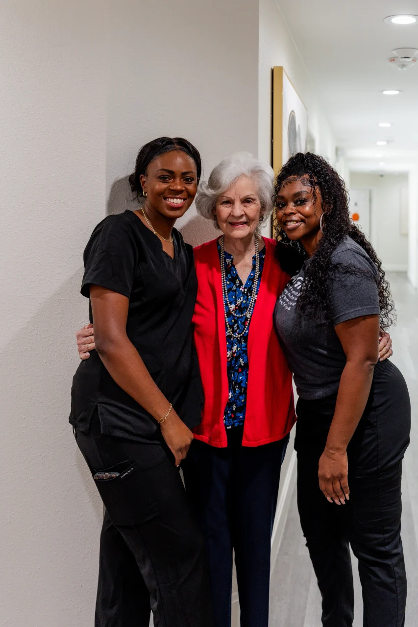 Three people smiling together