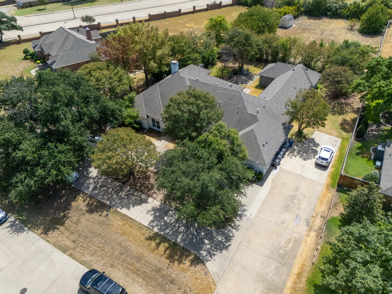 Aerial view of the home, trees and neighboring properties